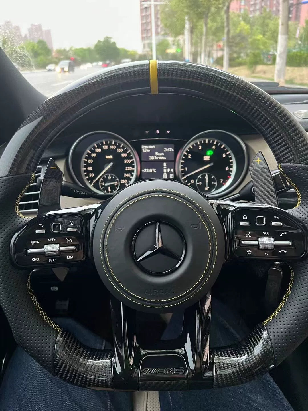 Custom Mercedes steering wheel in carbon fibre and perforated leather with yellow stitching and AMG trim